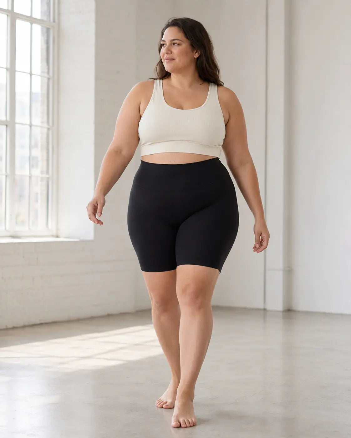 Model moving comfortably in the black LYROVA shorts